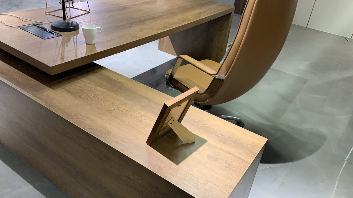 Wooden office desk with a chair in a modern office setting