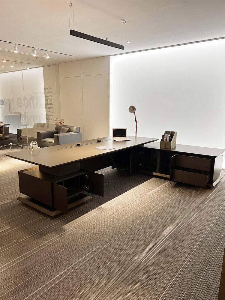 Modern office desk with a computer setup in a well-lit room.