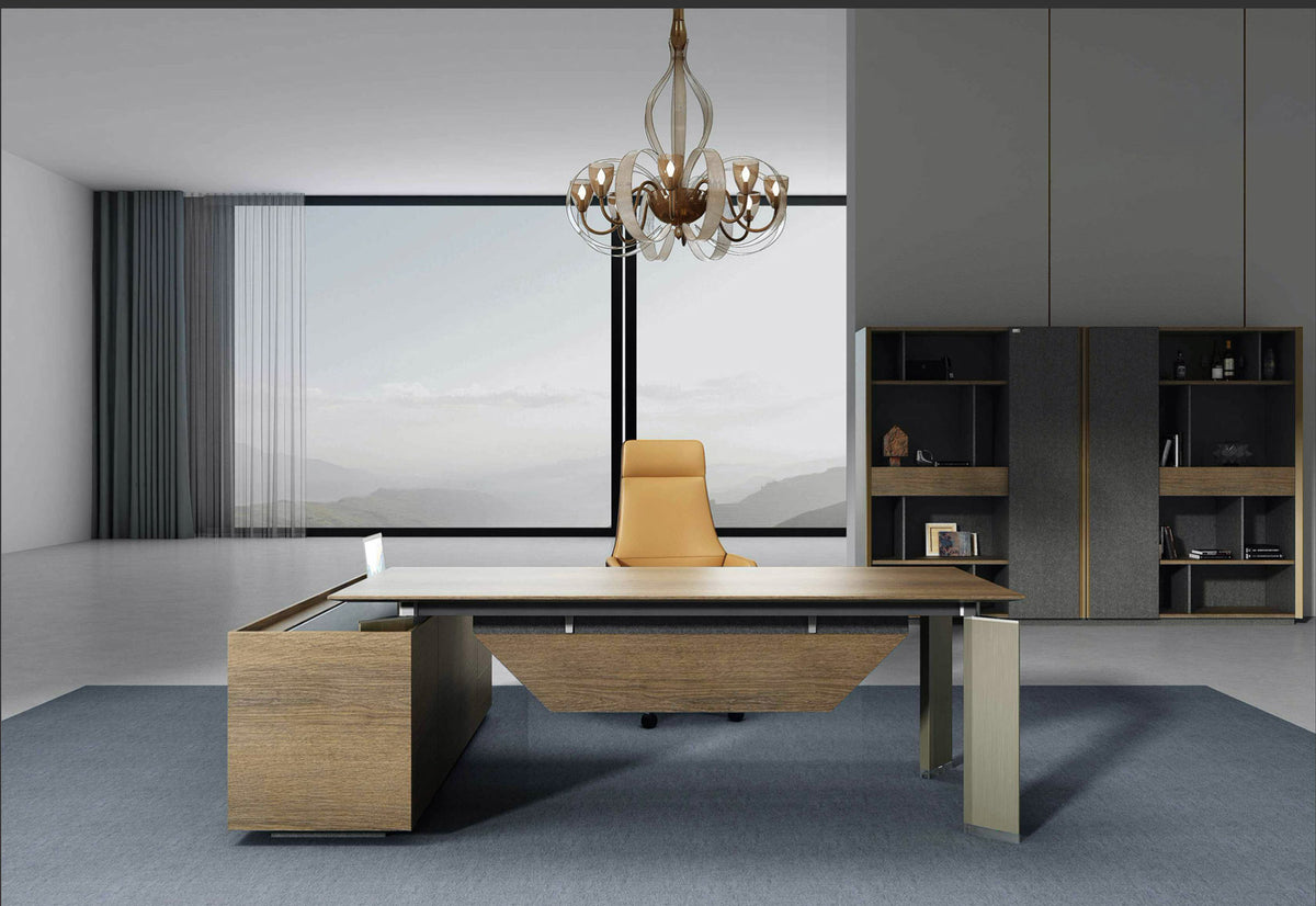 Modern executive office desk with brown oak finish and right return, featuring soft close drawers, metal handles and a chandelier above in a bright office setting.